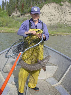 Man holding sturgeon in a net